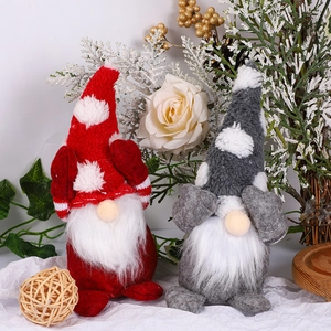 Close-up of cute Christmas gnomes with snowflake hats and long white plush beards