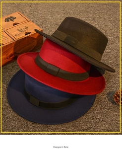 Close-up of flat-top wool felt fedora hats in black, red, and navy with ribbon bands