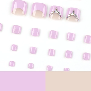 Lavender purple press-on toenails with rhinestone accents and French glitter finish