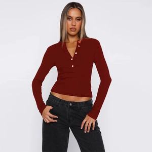 Detail of burgundy ribbed long sleeve knit cardigan with buttoned Henley neckline