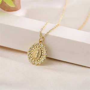 Detailed view of Virgin Mary pendant necklace with zircon halo on white silk fabric