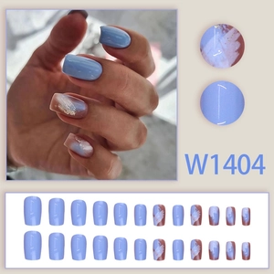 Sky blue marble press-on nails with gold foil accents in short square-oval shape