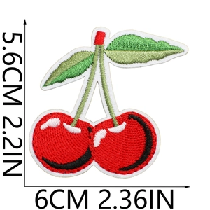 Close-up of red cherry embroidery patch with green leaves and precise stitching details