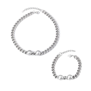 Minimalist silver stainless steel chain necklace and bracelet set on white background