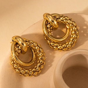 Elegant gold layered hoop earrings with textured bead ring and polished finish design