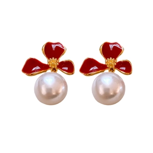 Elegant red flower and pearl earrings with golden details on a clean white background