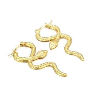 Detailed macro view of golden snake hoop earrings showing scale textures and hinged clasps