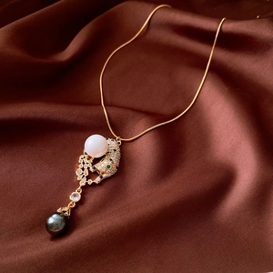 Detail of leopard head pendant with sparkling cubic zirconia and green crystal eyes