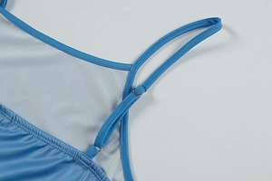 Detail of adjustable silver buckles on bright blue slim-fit dress shoulder straps