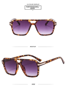 Detail view of tortoiseshell double bridge sunglasses with purple gradient lenses