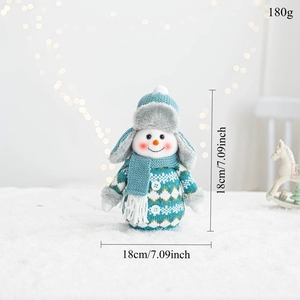Detail view of a knitted snowman doll ornament featuring white and blue plush textures