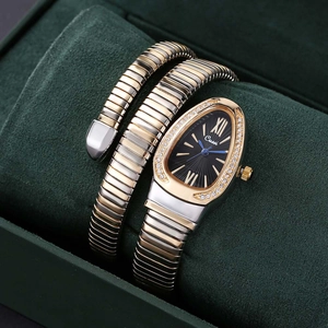Detail of snake wrap watch with crystal-set bezel and gold-silver Tubogas band