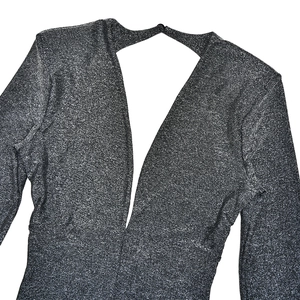 Close-up of deep V-neck dark grey glitter knit fabric with metallic texture detail