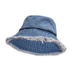 Detailed view of the frayed raw edges and textured denim stitching on a blue bucket hat