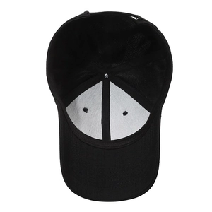 Internal structure of a black cotton baseball cap showing mesh support and stitching