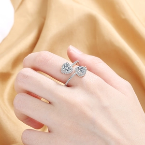 Elegant adjustable double heart ring with clear cubic zirconia on silk background