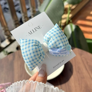 Detailed blue plaid bow hair clip featuring a clear button and delicate lace texture