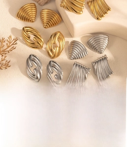 Detailed view of minimalist geometric titanium steel earrings in gold and silver finishes