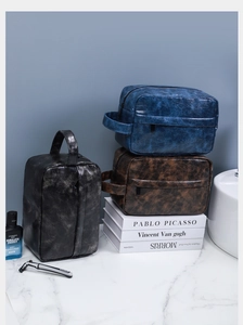 Three premium PU leather toiletry bags in navy, coffee, and black for business travel