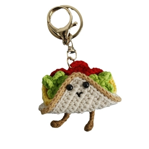 Handmade crochet taco keychain with colorful layers and golden metal hook on white backdrop