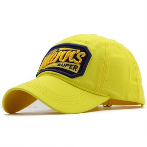 Detail of yellow baseball cap featuring navy hexagon patch and premium embroidery