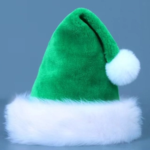 Close-up of green plush Christmas hat with soft white faux fur trim and fluffy pompom detail