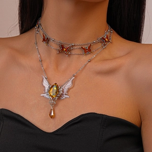 Elegant double-layered silver necklace featuring amber butterfly and droplet pendants