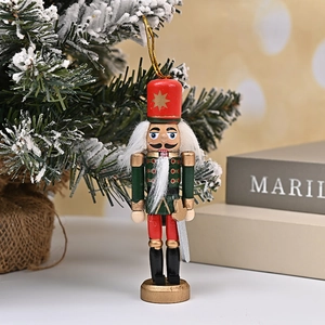Traditional 12cm wooden nutcracker soldiers hanging on a festive snowy Christmas tree branch