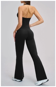 Detail of black sports set featuring backless halter top and high-waist yoga flared pants