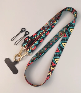 Detail of adjustable crossbody phone strap featuring a colorful tribal totem fabric pattern