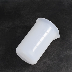 Detailed view of 120ml translucent silicone measuring cup with clear scale markers