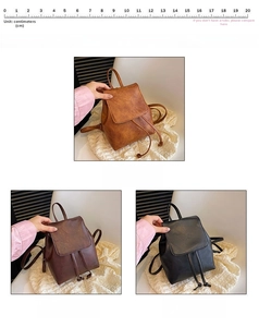 Detail view of small retro backpack in brown, coffee, and black with drawstring closure