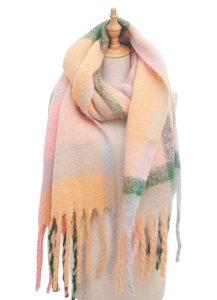 Close-up of pink yellow and green checkered scarf with fringe on a white background