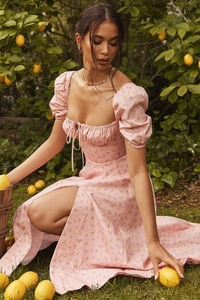 Detail shot of a pink floral puff sleeve maxi dress with side slit in a sunny lemon grove