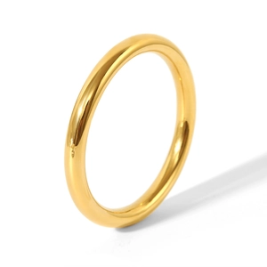Macro view of polished 18K gold plated stainless steel minimalist bangle with smooth finish