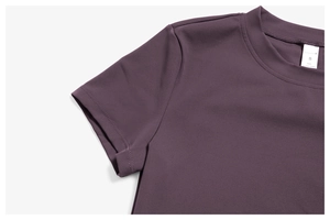 Close-up of neckline and size S label on a brushed dark purple yoga sports t-shirt