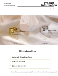 Macro detail of gold and silver stainless steel open rings with initial letter designs