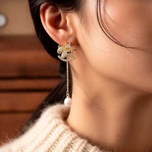 18k gold plated rocking horse earrings with pearls and tassels on model