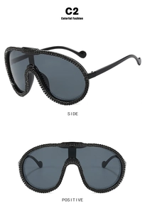 Detail of oversized cycling sunglasses with crystal rhinestones and dark lenses