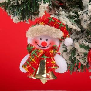 Close-up of plush snowman ornament with red-green plaid scarf and a gold metal bell