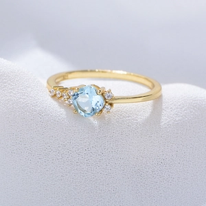 Sky blue topaz sterling silver ring with gold plating and round cut center gemstone