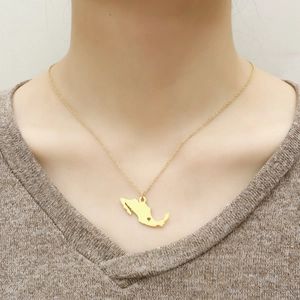 Golden Mexico map necklace featuring heart cutout detail worn on a model neckline
