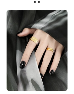 Detail shot of two-tone S925 silver wide open rings with wrinkled lava texture on hand