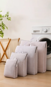 Macro detail of honeycomb mesh laundry bags with zipper closure in four sizes