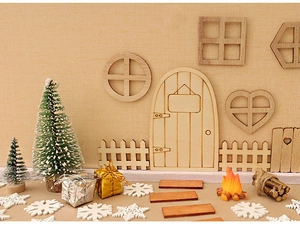 Detailed view of DIY miniature wooden Christmas door kit with fences and gift boxes