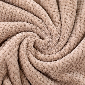 Soft coral fleece towel set with pineapple grid texture in a khaki brown rolled style