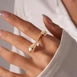 Minimalist gold irregular geometric ring with a molten metal liquid sculpture design