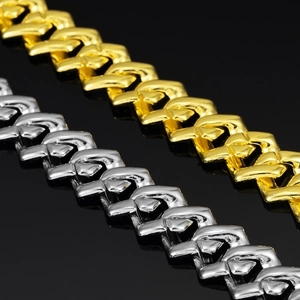 Detail of 15mm cuban chain in gold and silver finish with flat V-shape link pattern