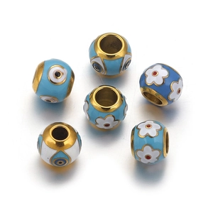 Macro shot of blue evil eye and white flower enamel stainless steel beads for DIY jewelry