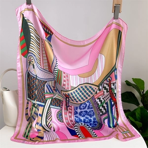 Close-up of pink imitation silk scarf with geometric graffiti patterns and silky texture